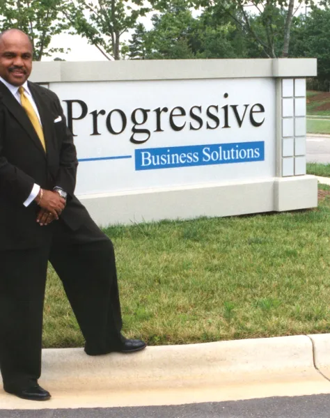 Tim with company sign