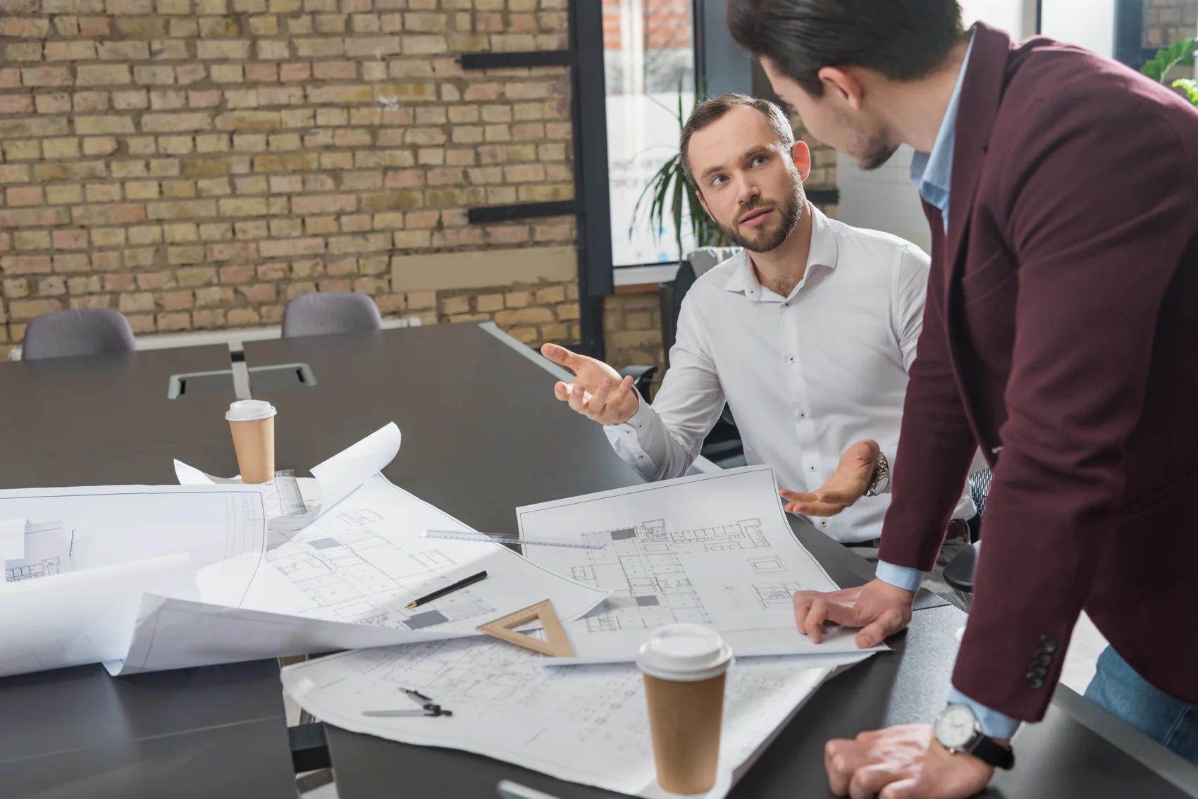 Architects brainstorming over building plans